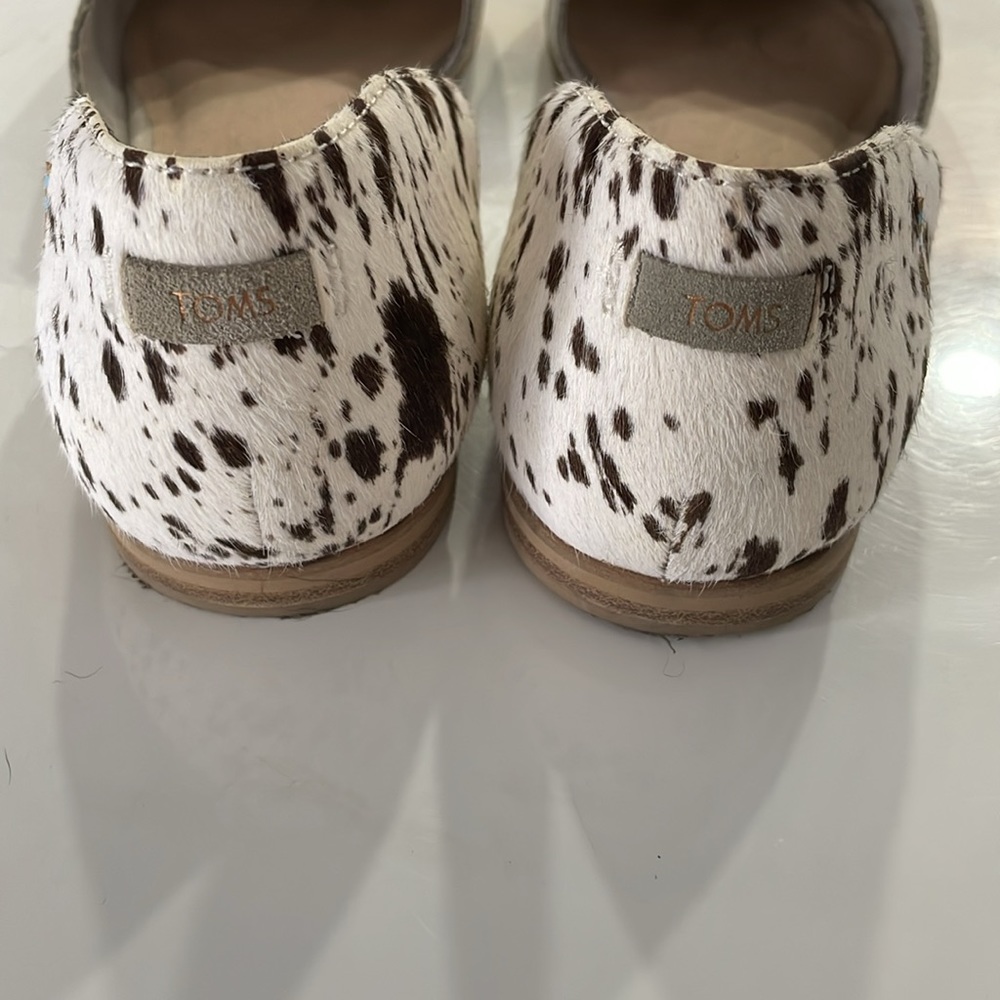 Tom’s cow hide flats.
